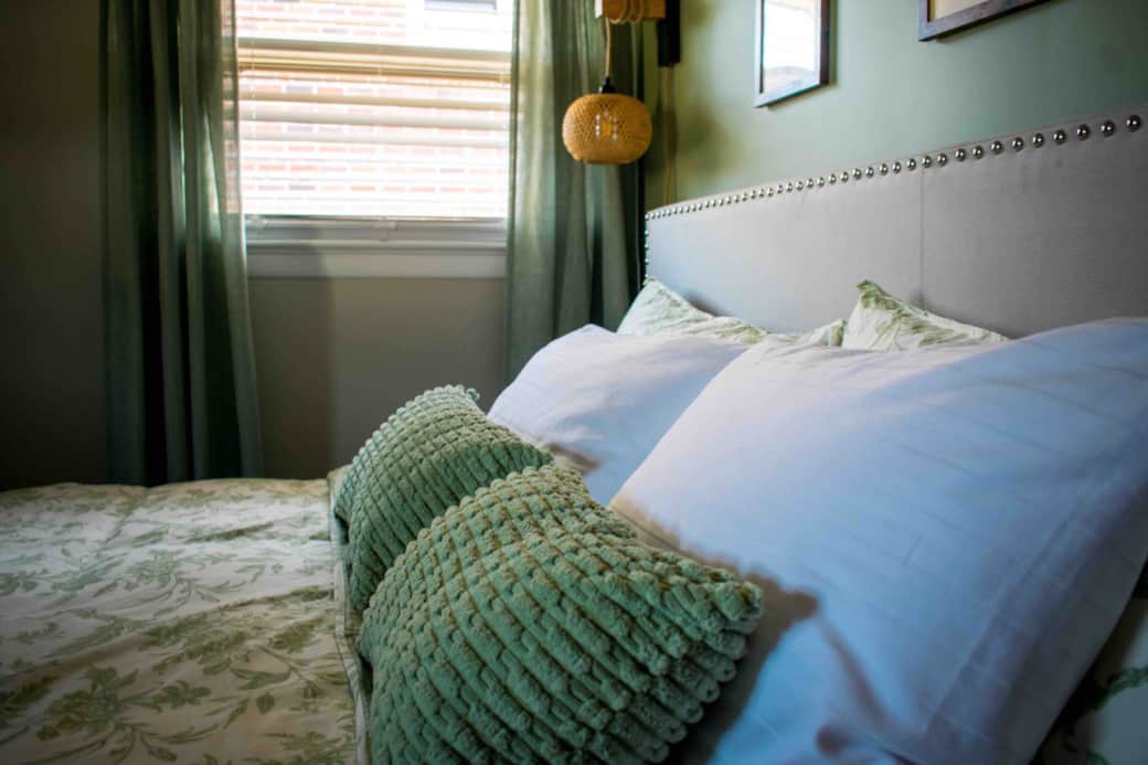 Serene king bedroom in calming sage tones—your peaceful retreat for rest and relaxation.
