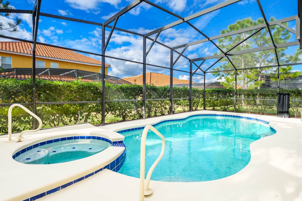 There is a raised Jacuzzi spa attached to the pool area