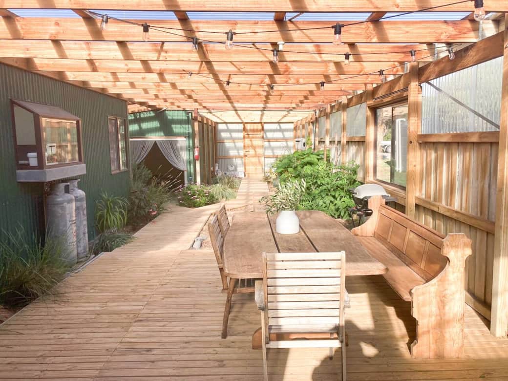 The indoor atrium is perfect for entertaining in cooler months. The space features an outdoor fireplace, dining area, BBQ and vegetable and herb garden