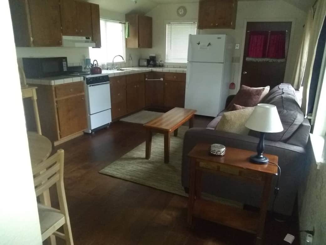 The front room, towards the full kitchen and front porch The front room, towards the full kitchen and front porch