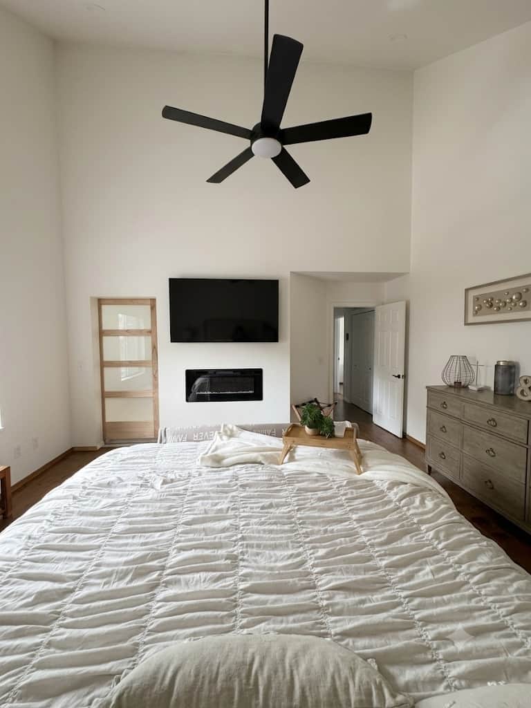  Newly remodeled master bedroom featuring a cozy electric fireplace, TV, ceiling fan, and a relaxing atmosphere designed for comfort and rest.