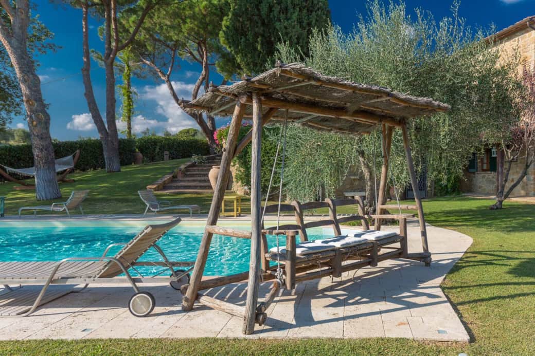Swimming pool with wooden swing