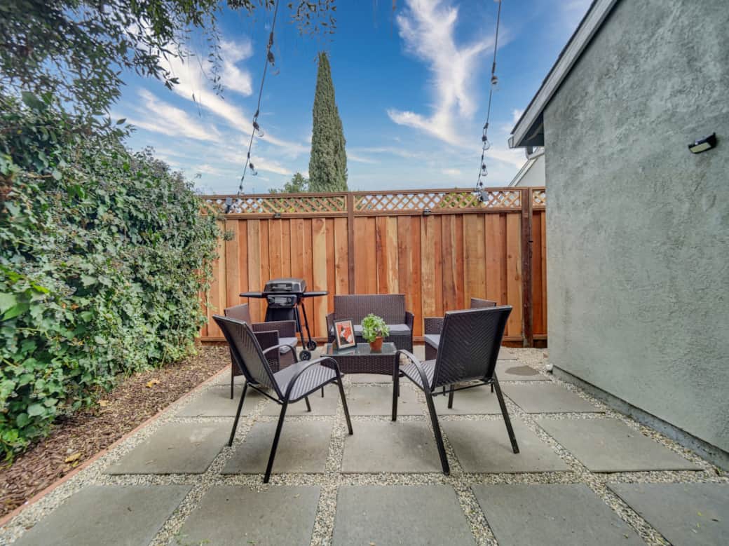 Newly renovated/ welcoming shared backyard featuring a willow tree, brand-new furniture, and a BBQ