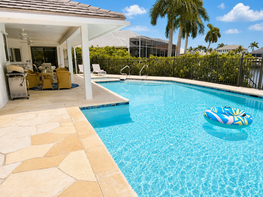 Your private backyard retreat with a heated pool, spa, and waterfront setting. Your private backyard retreat with a heated pool, spa, and waterfront setting.