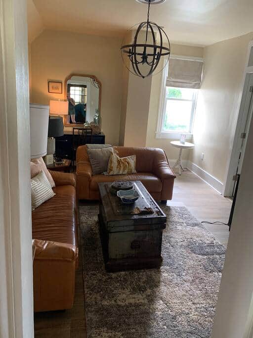 Living room has sofa and love seat, smart TV, and desk and chair to use for studying or work. Living room has sofa and love seat, smart TV, and desk and chair to use for studying or work.