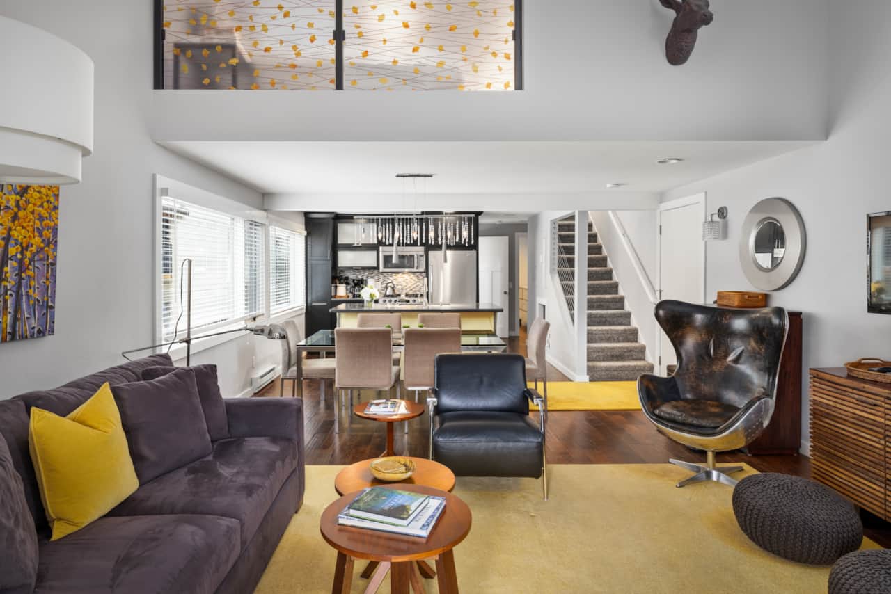 Comfortable living room sitting area with high ceilings and gas fireplace