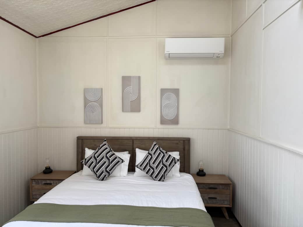 Comfortable downstairs bedroom with air conditioning and spacious wardrobe.