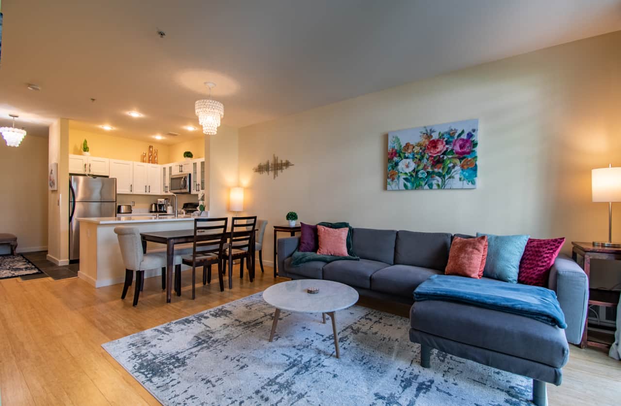 Living Room with Spacious Couch and 6 Person Dining Table
