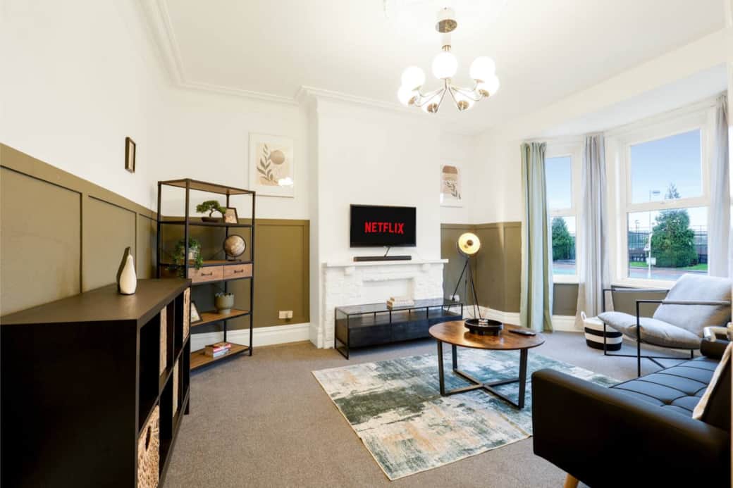 Bright, spacious living area with comfortable seating, smart TV, and plenty of room for everyone to unwind after a long day. Ideal for relaxing, socialising, or movie nights with your group. Bright, spacious living area with comfortable seating, smart TV, and plenty of room for everyone to unwind after a long day. Ideal for relaxing, socialising, or movie nights with your group.