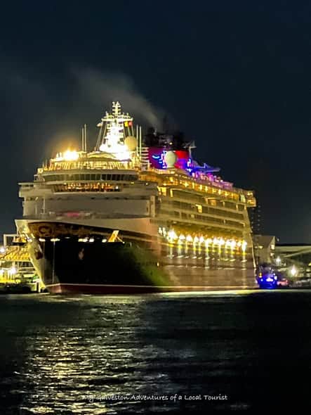 Disney cruise ship illuminated at night departing from the Port of Galveston
