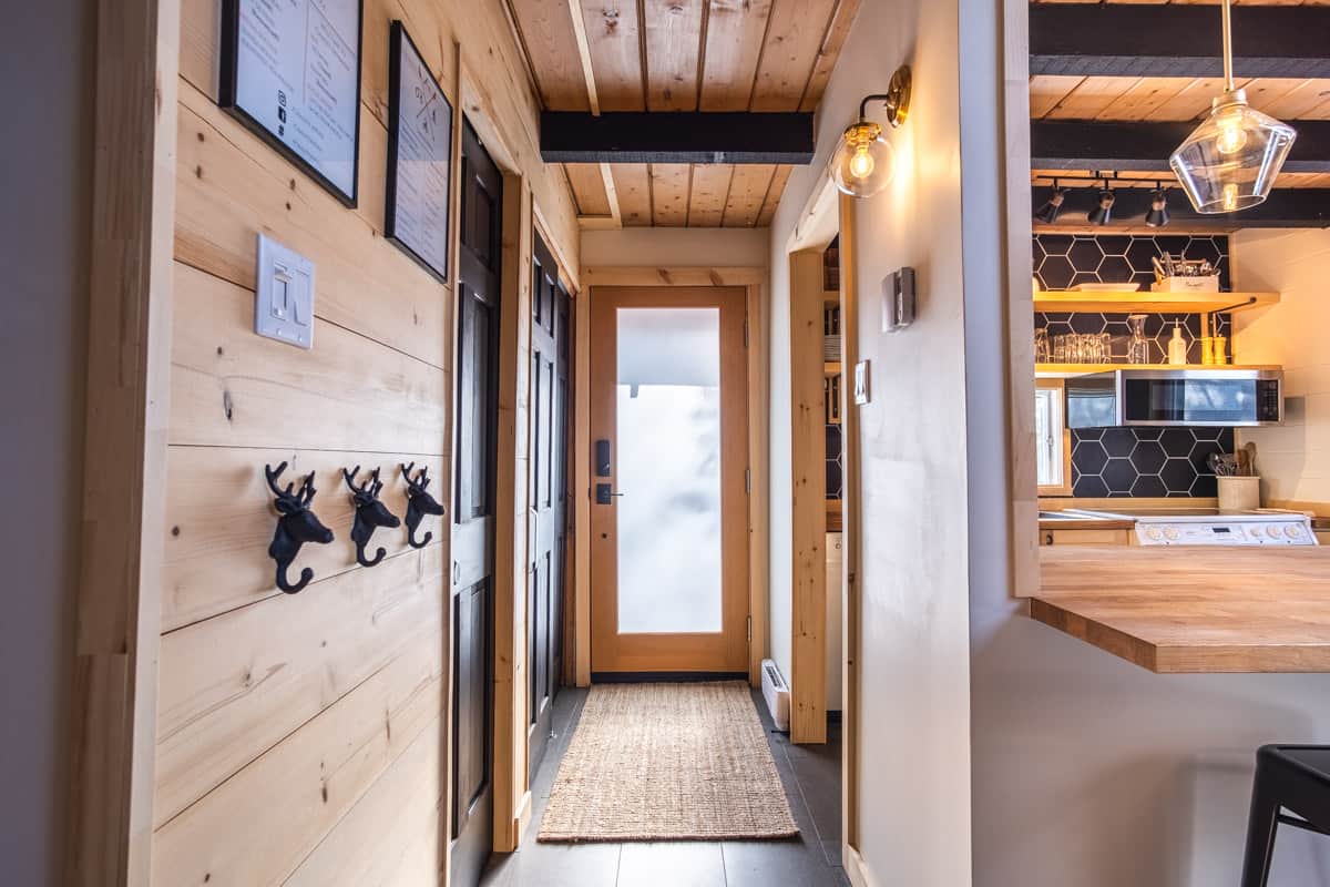 Entryway  with kitchen on one side and entry closet & full bathroom on other side