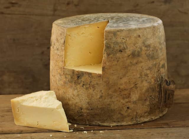 A wheel and wedge of Isle of Mull farmhouse cheese