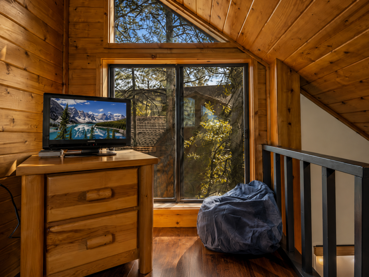 Loft entertainment area with forest views at cabin
