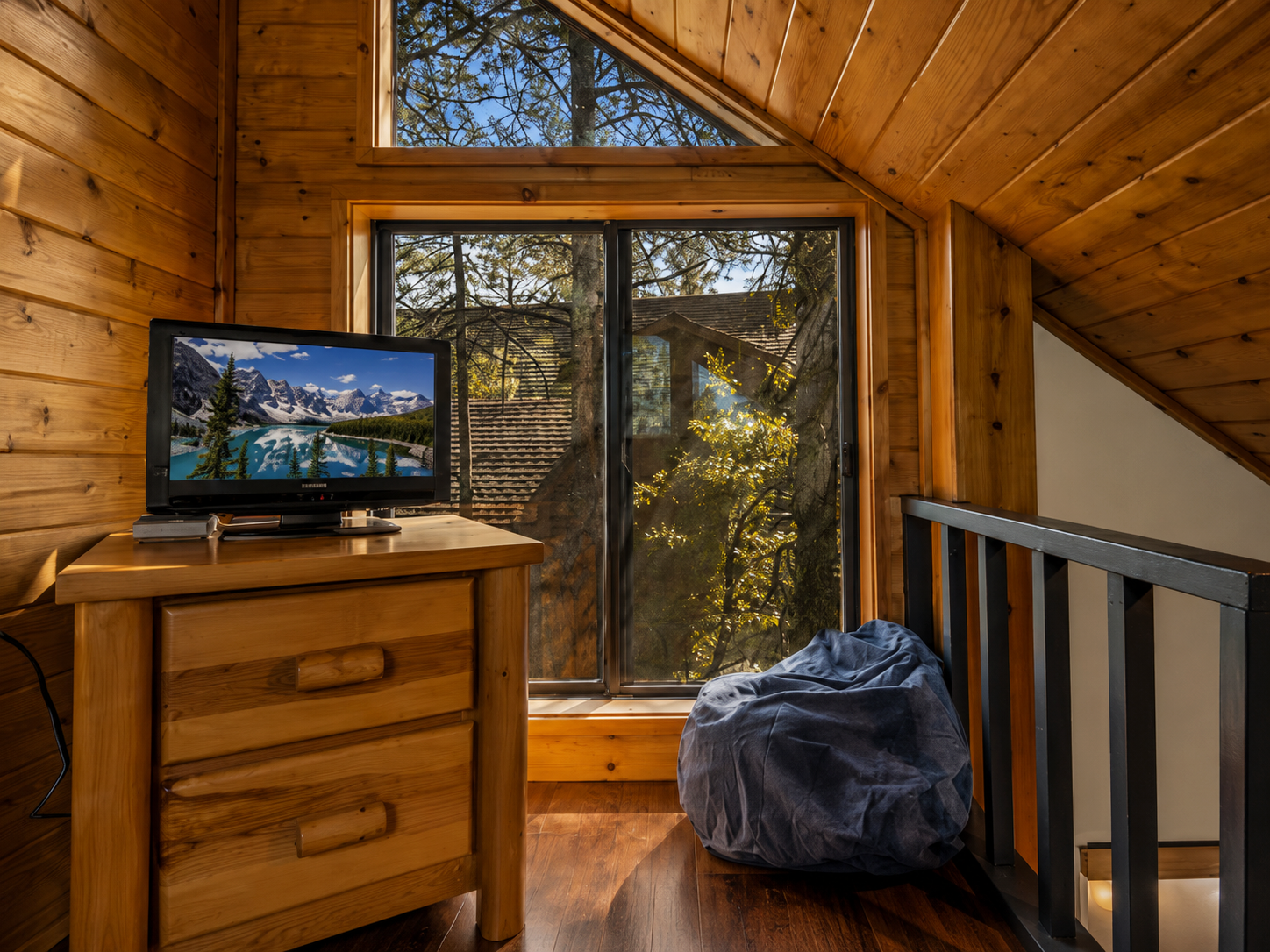 Loft entertainment area with forest views at cabin