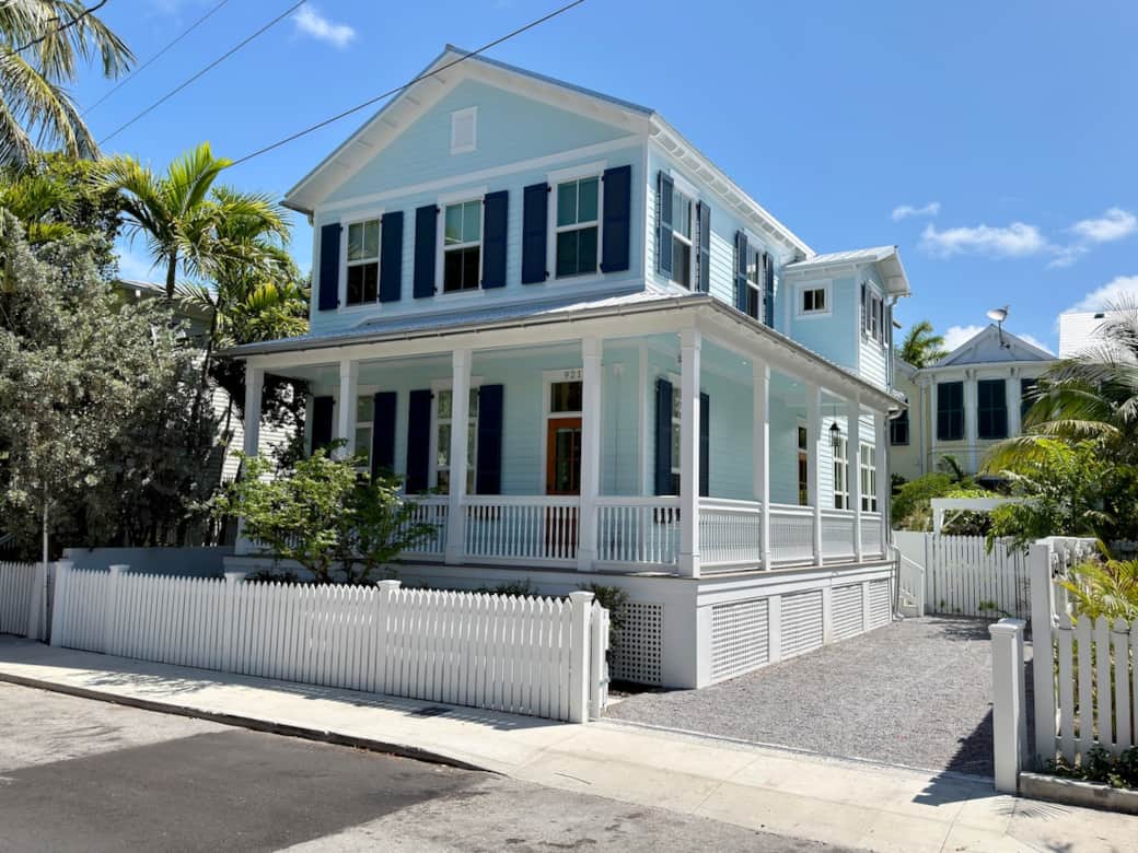 A classic Old Town exterior with wraparound porches, tropical landscaping, fully gated 2 standard spaces of off-street parking, and a peaceful private setting. The home also includes Tesla and golf cart charging stations for added convenience.