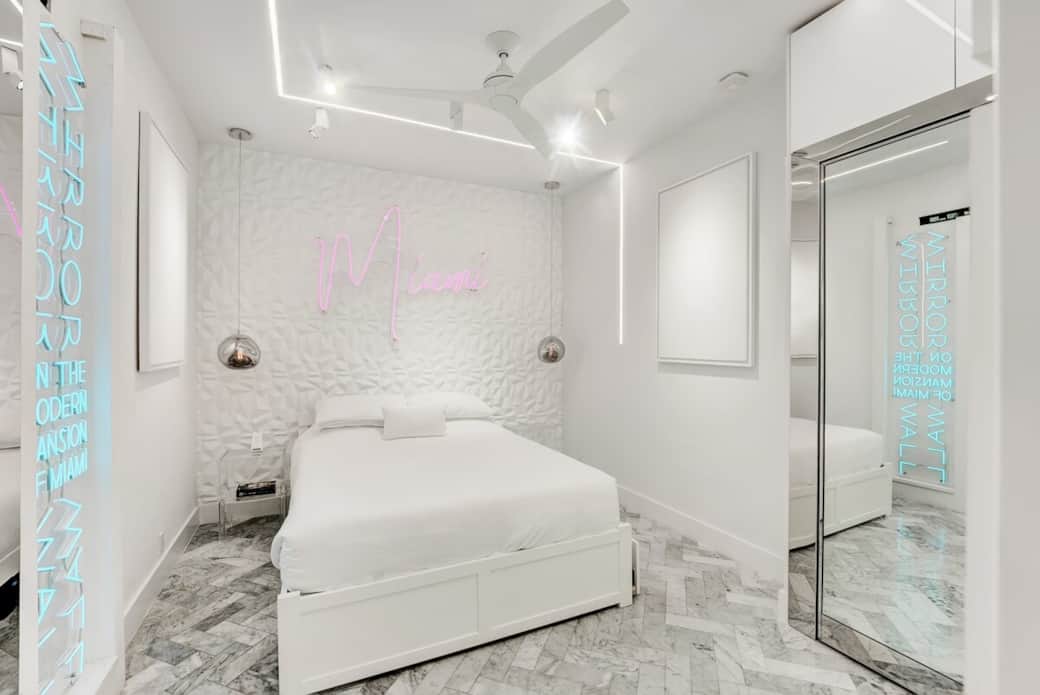 1st FLOOR: THIRD BEDROOM features 1 queen + twin XL pullout trundle bed (sleeps 3). This room also features 2 custom neon signs. Hidden sliding mirrored door separates bedroom from living room / party lounge. Connected bathroom. Kohler fixtures. 