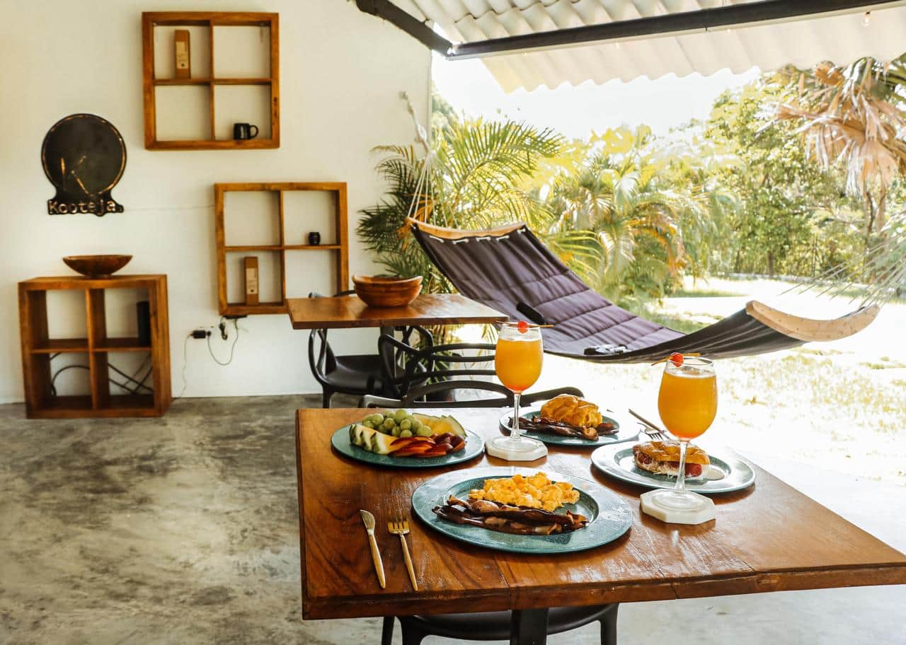 Breakfast on a covered terrace with hammock at Kooteja Coronado, a sustainable stay in Panama
