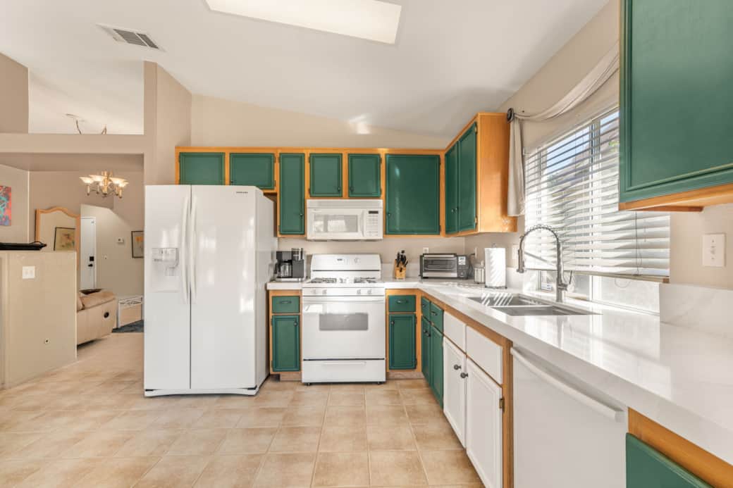 Spacious U-shaped kitchen with ample countertop space for meal prep. Spacious U-shaped kitchen with ample countertop space for meal prep.