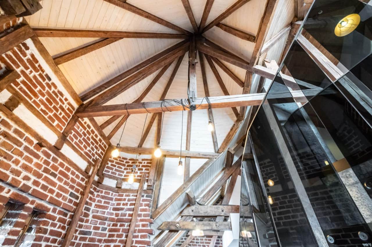 Exposed brick and wooden beam details in Central Bucharest duplex