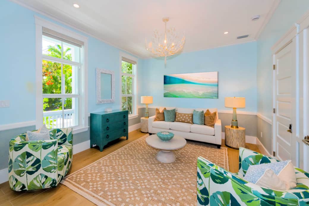 Bright living room near the entry with elegant coastal-modern style and cozy seating.