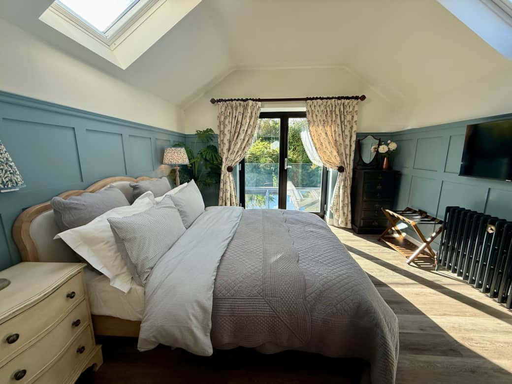 Spacious king-size bedroom with bright windows and en-suite