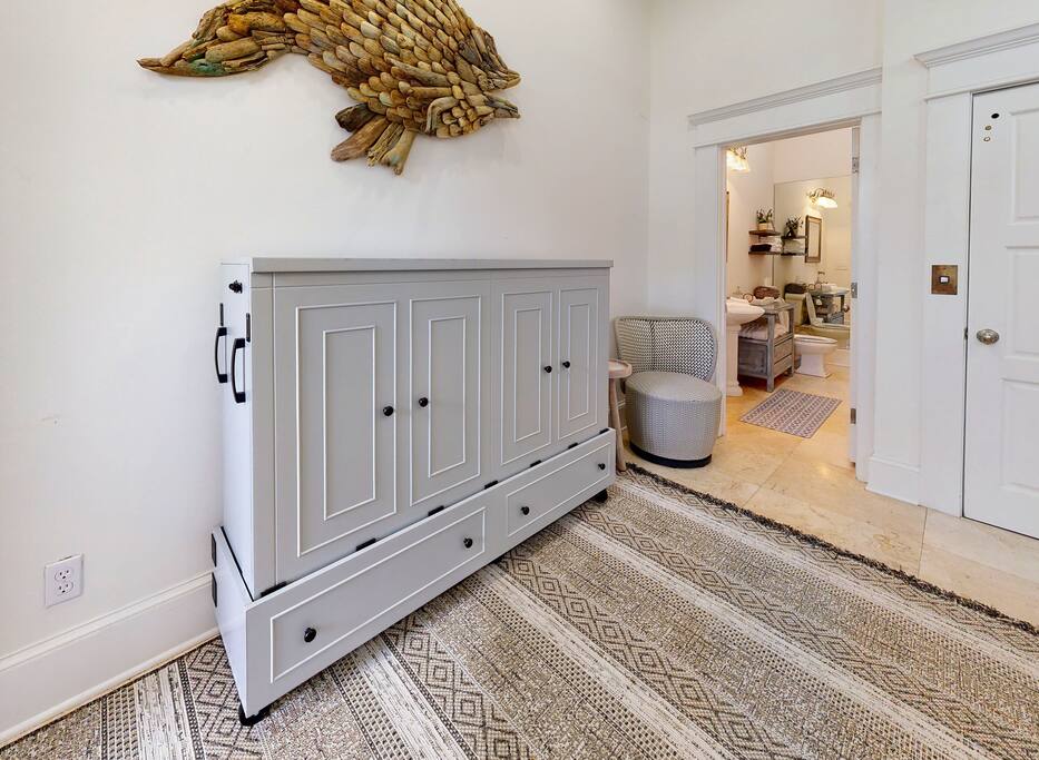 Queen size murphy cabinet bed in multipurpose entry room.