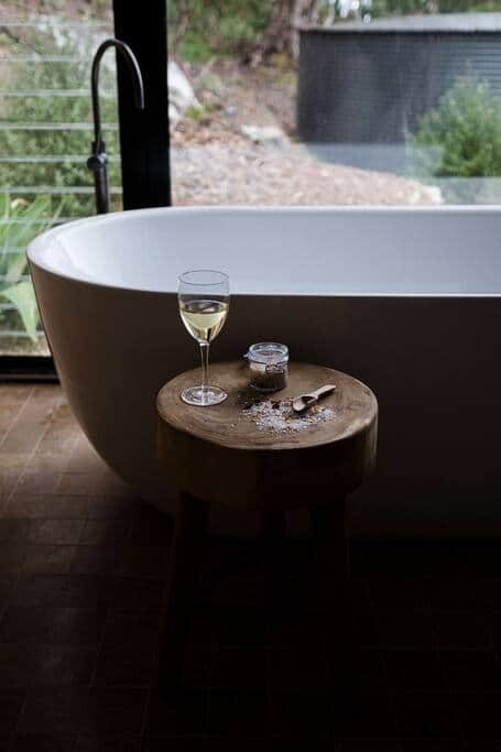 A serene outlook from the luxurious bath looking out over the landscape and dams beyond