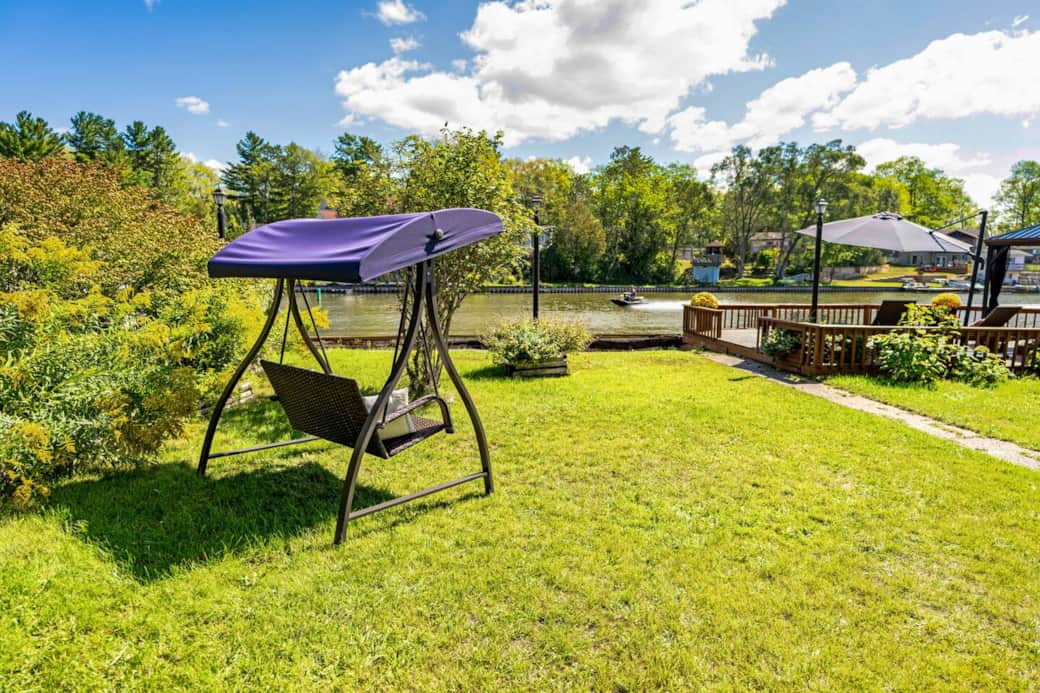 Sitting on the swing by the river, you're enveloped in a serene atmosphere. As you sway back and forth, your senses are captivated by the soothing melodies of nature, creating a timeless moment of tranquil contemplation.