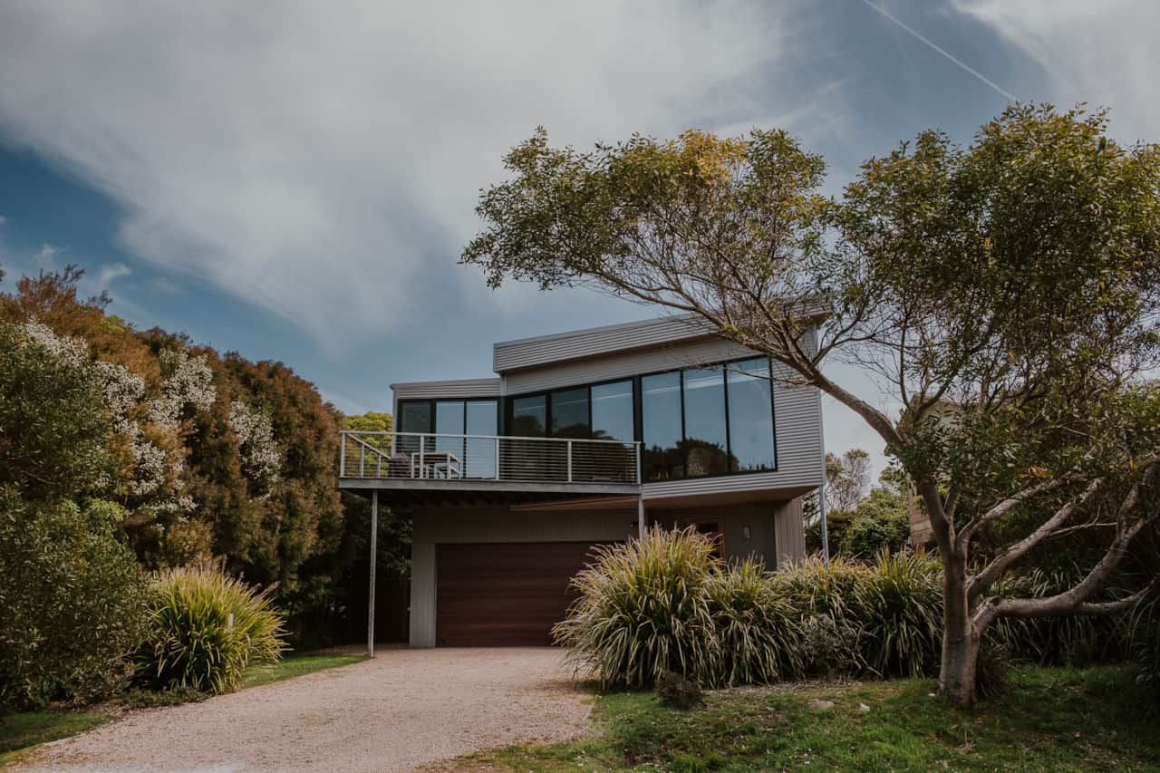 Shearwater Beach House exterior with floor-to-ceiling windows and coastal garden, Walkerville North 
