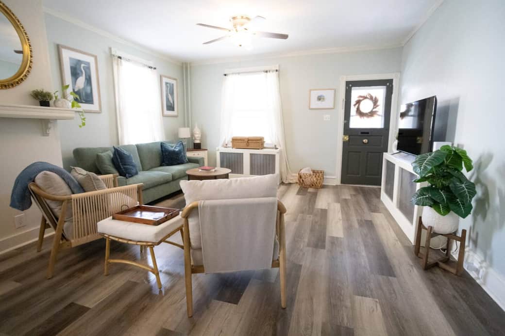 Relax in the airy living room featuring modern furnishings, soft seating, and plenty of natural light. Thoughtful artwork, greenery, and cozy textures create a calm, inviting space for guests to unwind.