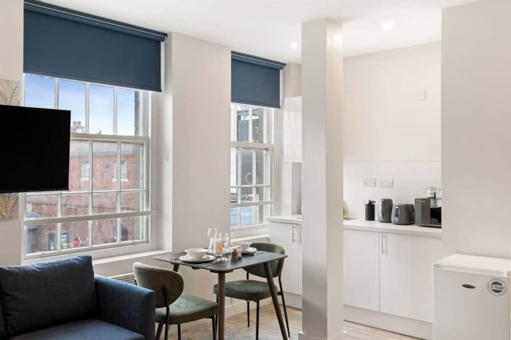 A sleek, modern kitchenette fully equipped with essentials including kettle, toaster and fridge. A sleek, modern kitchenette fully equipped with essentials including kettle, toaster and fridge.