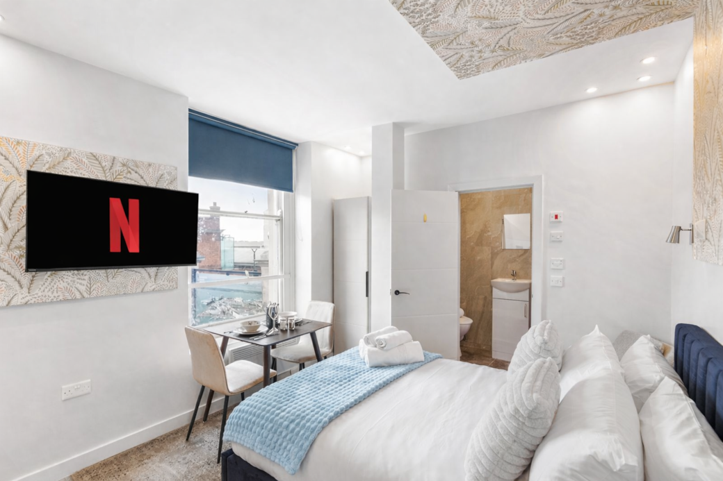 right and stylish bedroom featuring a plush double bed with luxury linens, right and stylish bedroom featuring a plush double bed with luxury linens,