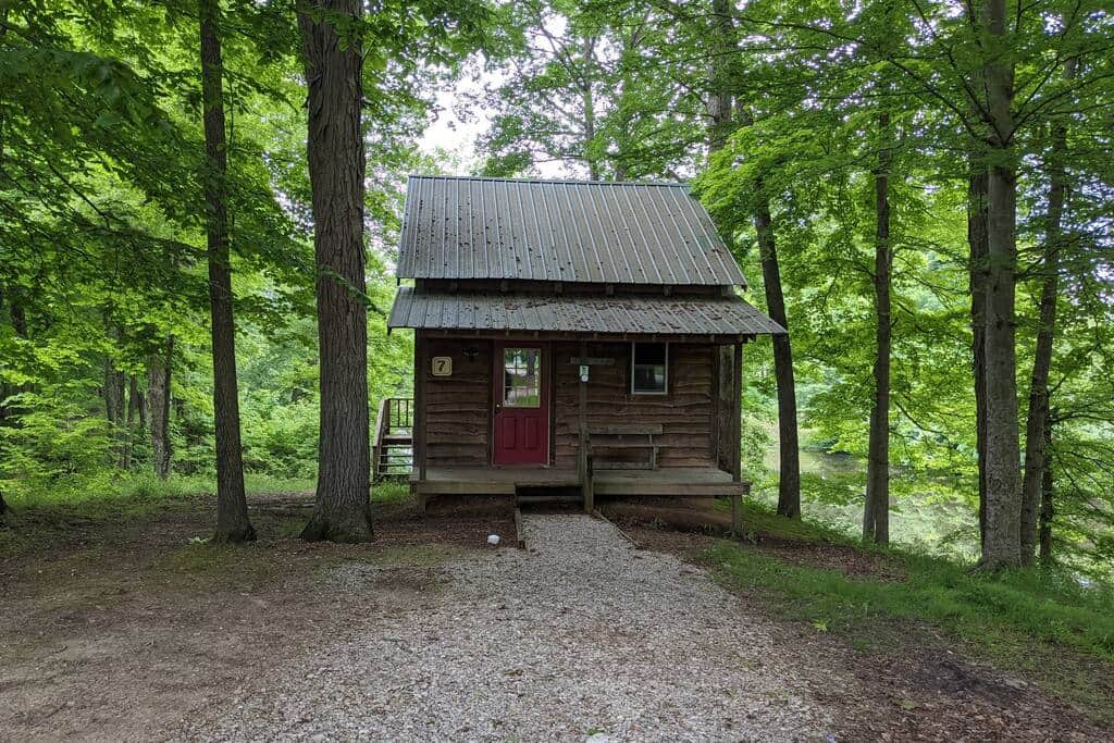 Outside view of Cabin 7 with lake in the back.
