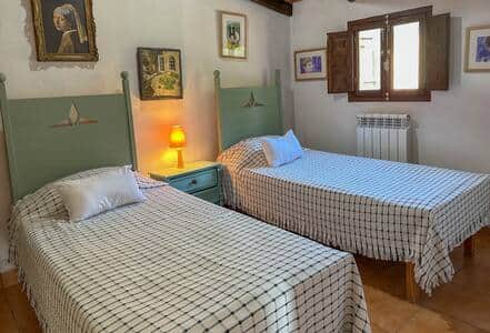 Twin beds with ceiling fan