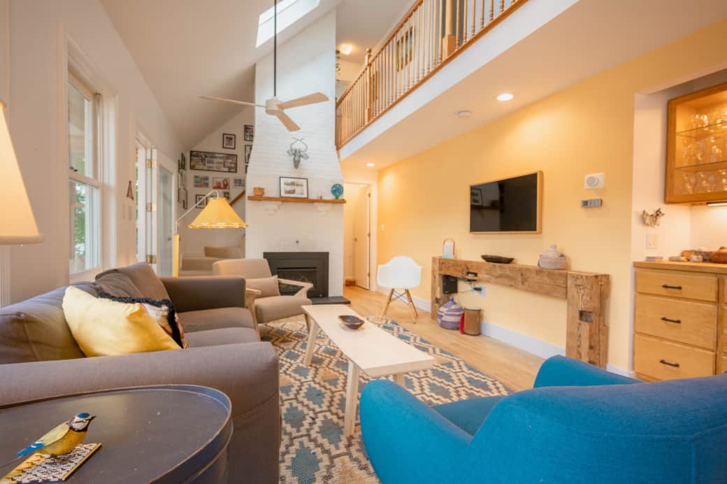 Relax in the cathedral ceilinged living room with hand-built furniture and gas fireplace. Relax in the cathedral ceilinged living room with hand-built furniture and gas fireplace.