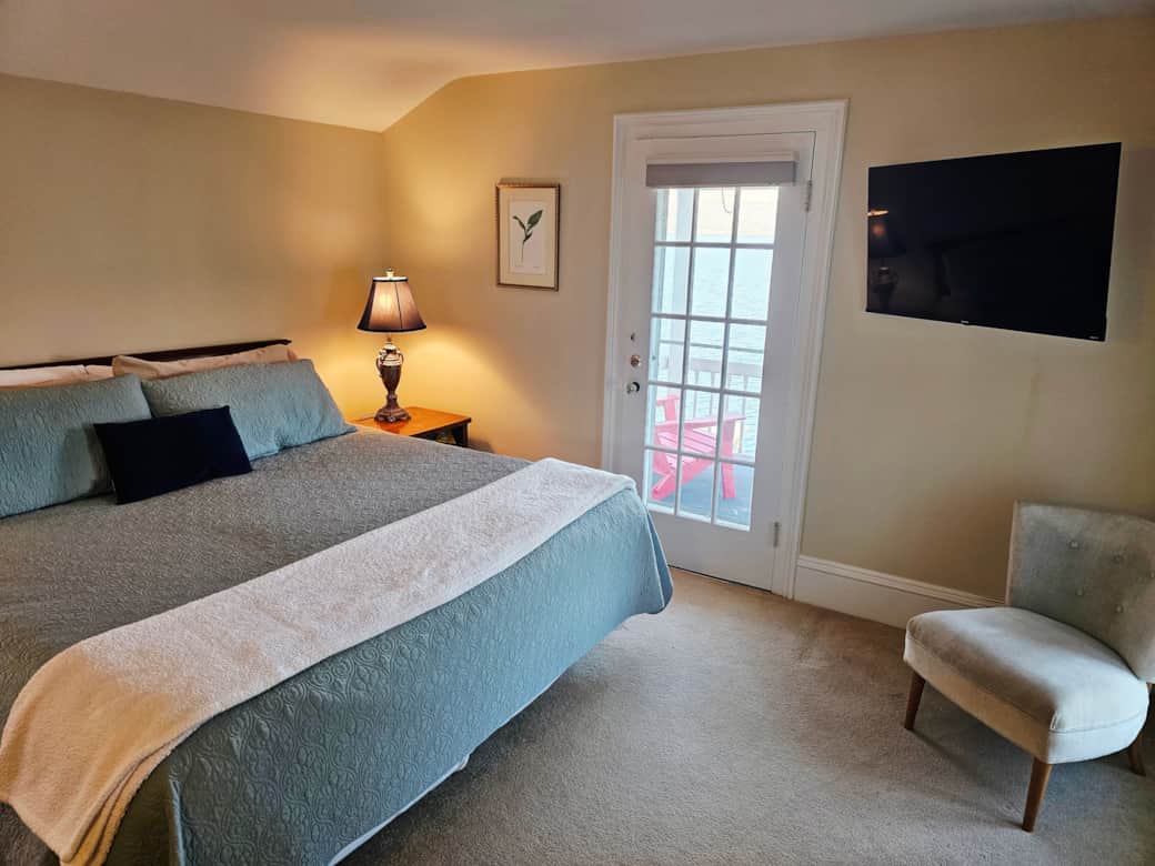 The upstairs king has a private balcony facing the lake, TV, mini split air, closet, dresser