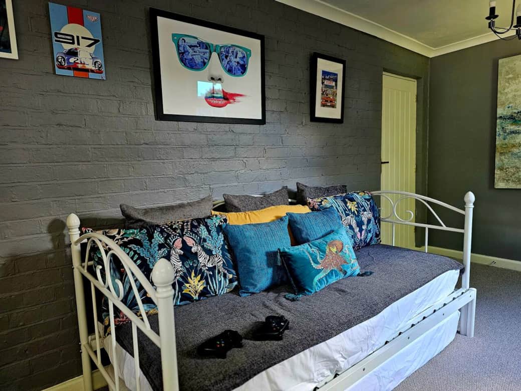 Bedroom 5 can also be used as a study with a day bed, computer monitor, xbox, and home working set up.