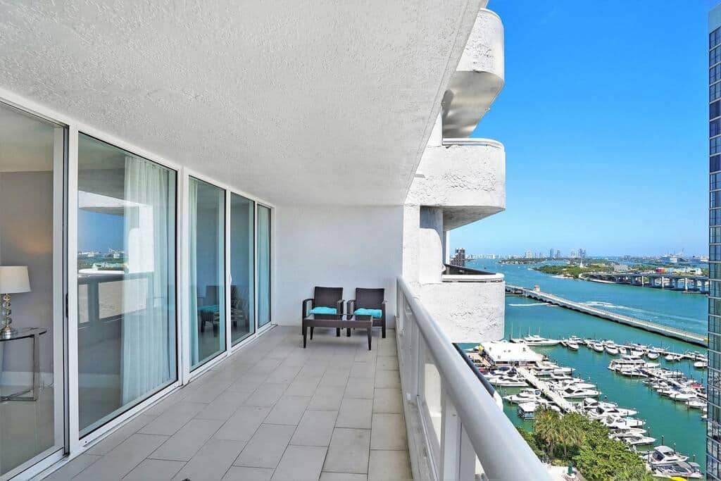 Furnished balcony with water views of Biscayne Bay, Venetian Marina,  downtown Miami and pool