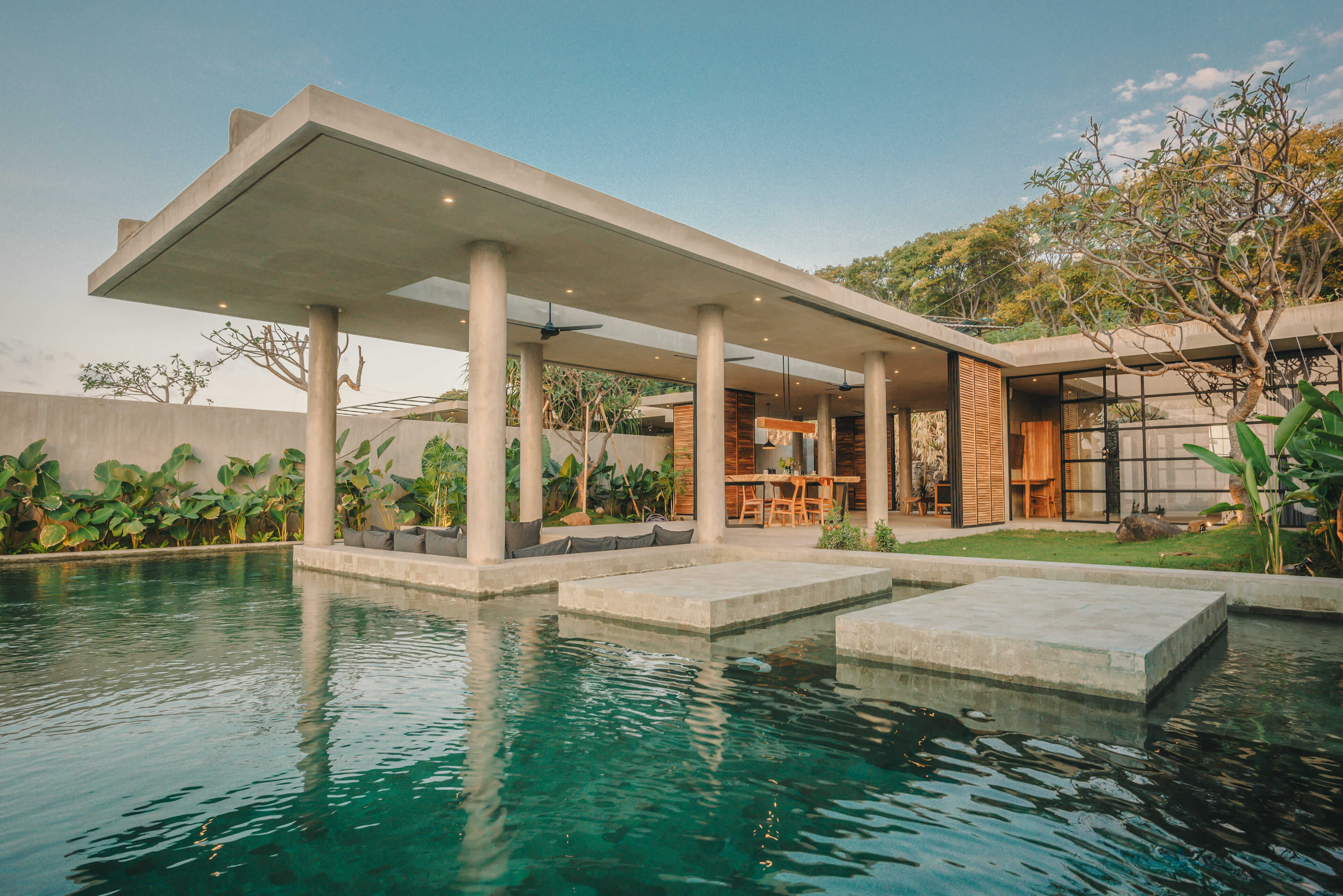 Private infinity pool and covered terrace at Villa Yolanda, Sumberkima Hill with concrete columns and stepping platforms