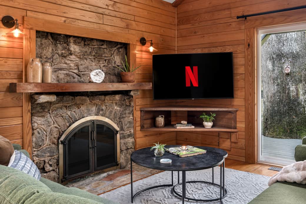 Cozy by the wood stove, stream on the 55" TV, with skylights and deck access to nature’s beauty.