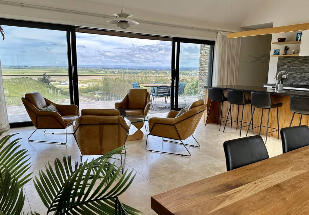 Super comfy leather chairs looking out to that endless view… sliding doors open right up so there’s always a lovely breeze. the perfect kitchen/dining area for entertaining, complete with scullery. Electric shade area outside for outdoor table area