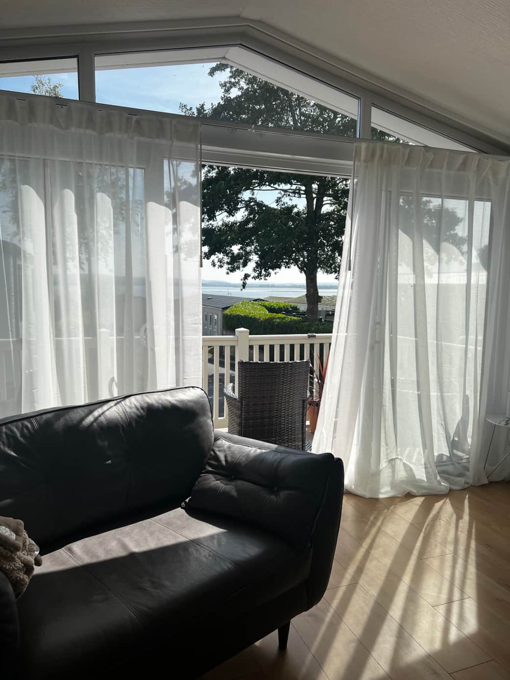 Our open-plan living room is designed for relaxation. Bay windows that flood the space with light.