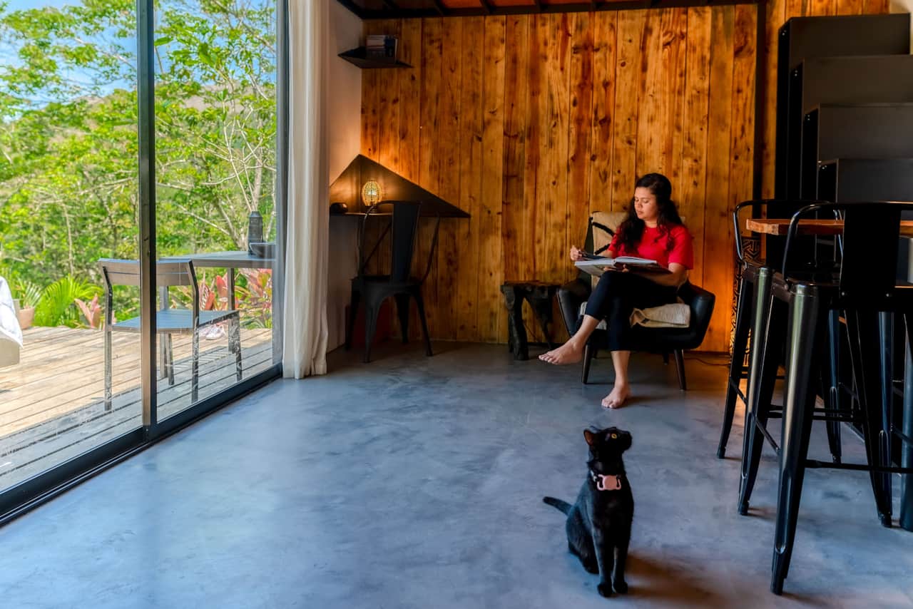 Floor-to-ceiling glass opens onto the rainforest at our off-grid cabin in Valle de Antón