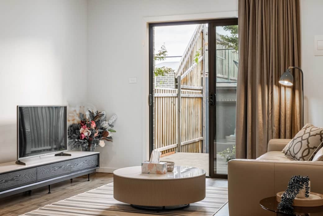 Step into our living room, where modern design meets homely comfort. The plush sofa and stylish coffee table create a perfect spot for relaxation. Enjoy the natural light streaming in through the patio doors, offering a serene view of the outdoors.