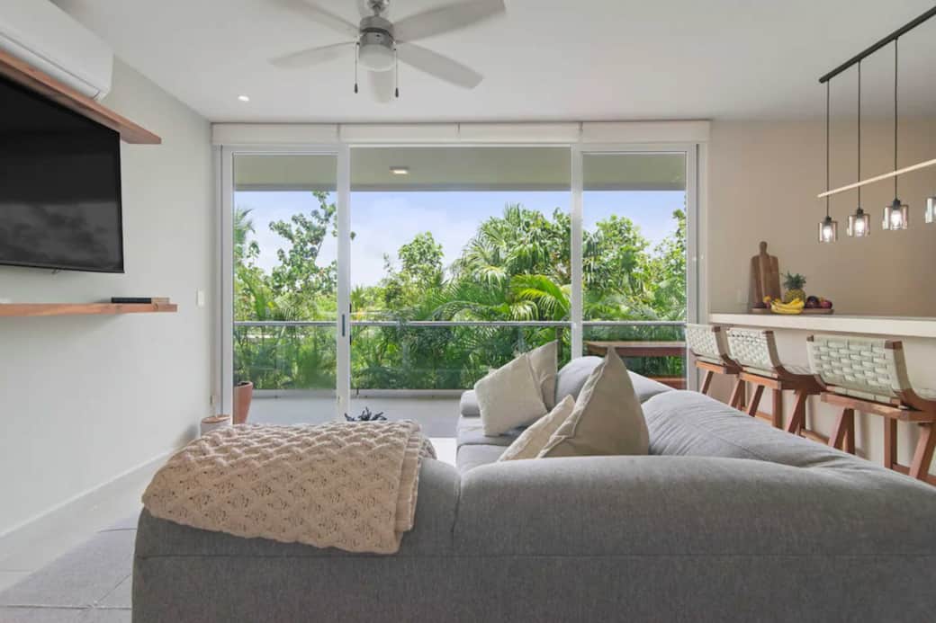 Relax with family in our unique living room, watching TV with jungle views.