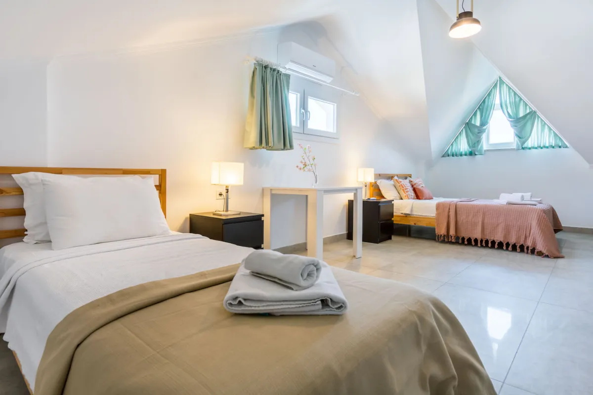 Bedroom with two beds, a small table, and lamps, Villa Nergis 2, Gocek.