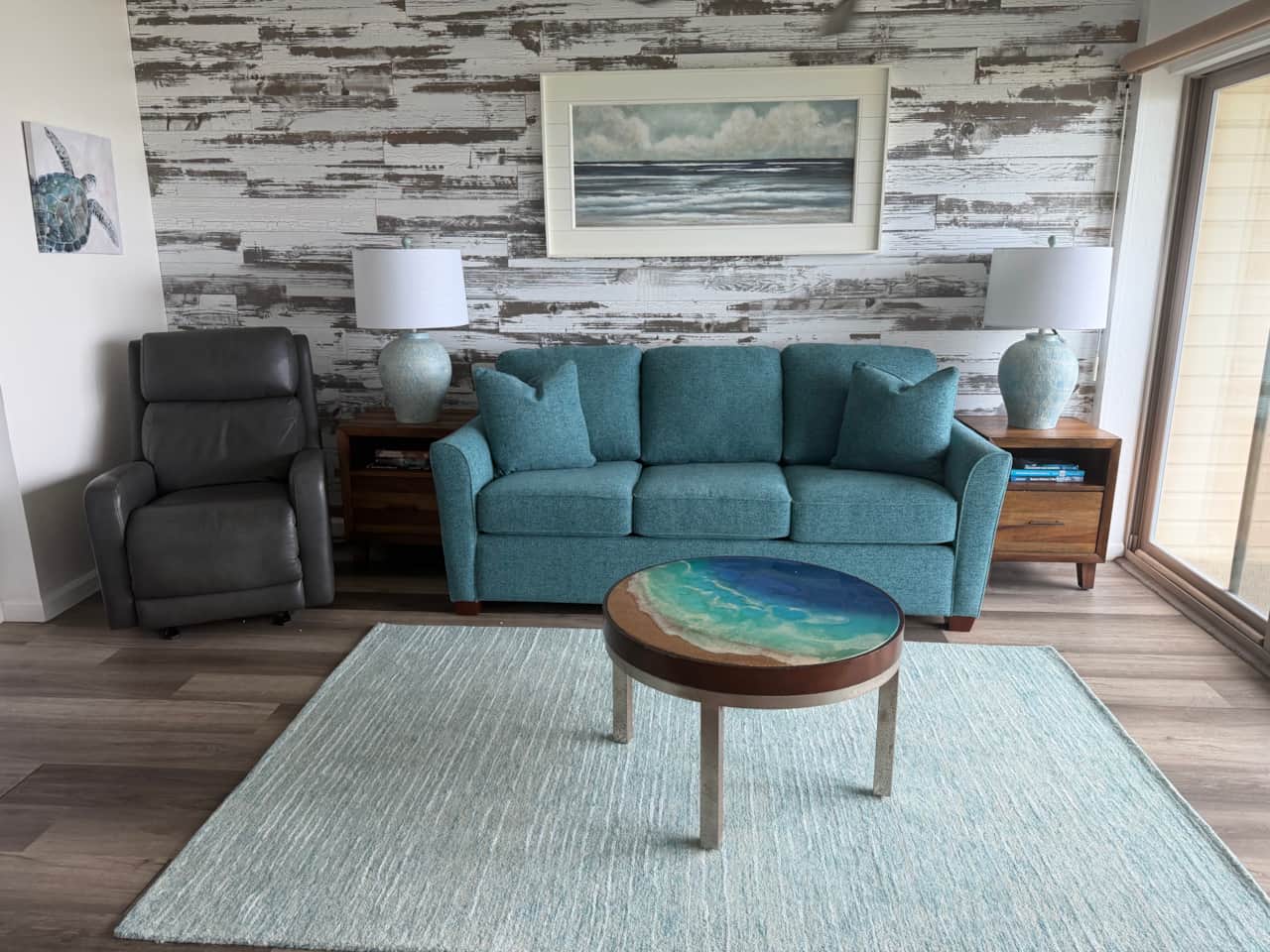 Bright living room with comfortable seating and beautiful ocean views from the lanai.