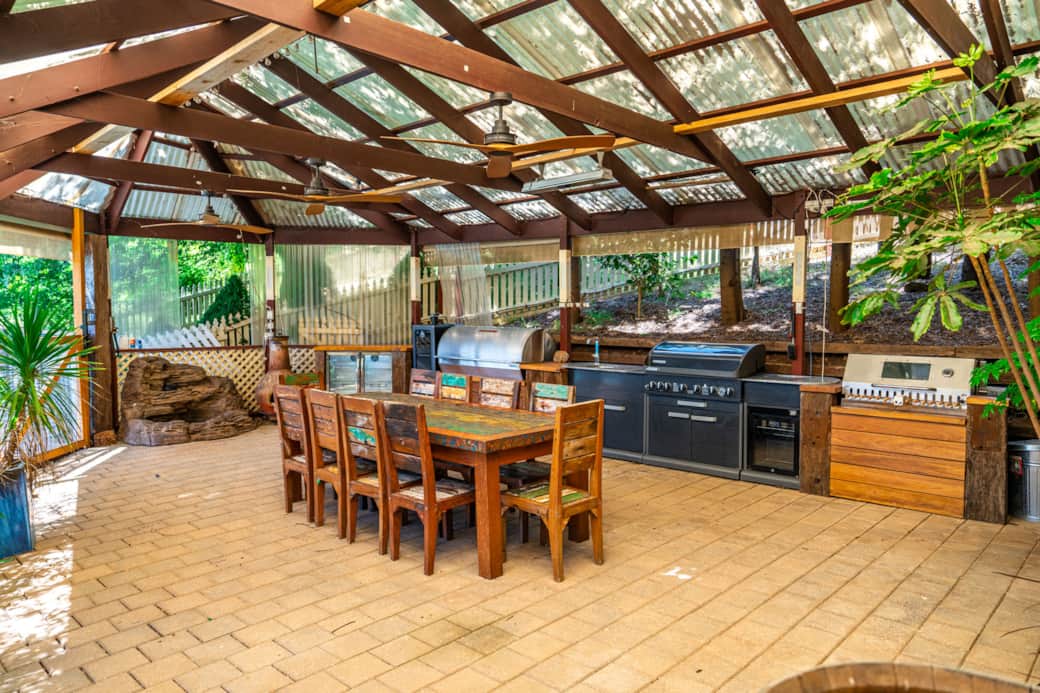 BBQ area with 10 seat table adjacent to the pool deck