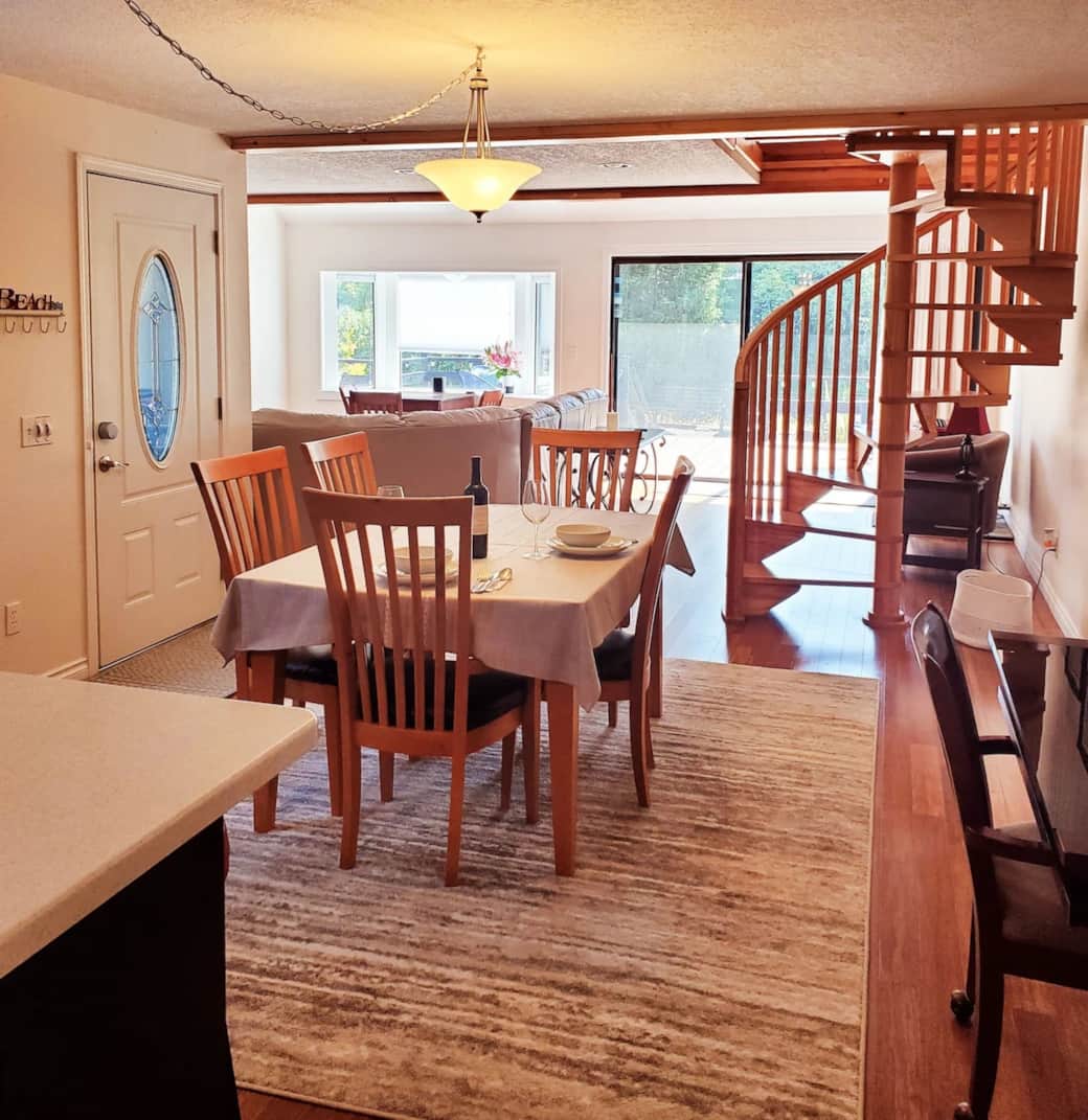 View from Kitchen to dining room past staircase to deck