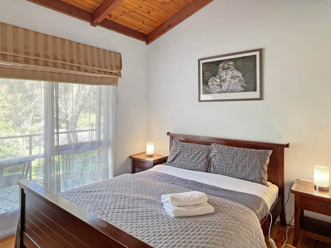 Serene sleep space: Bedroom 1, featuring a luxurious queen bed. Sweet dreams await!